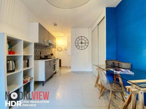 une grande cuisine avec un mur bleu et une table dans l'établissement Le Libé 207 - Nice centre - Libération, à Nice