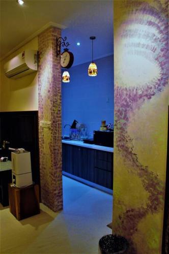 a kitchen with a counter and a bar in a room at Boutique Studio- Riverine Diamond in Kuching