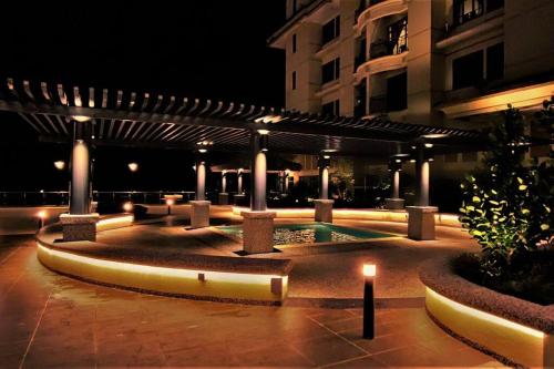 a building with a lit up courtyard at night at Boutique Studio- Riverine Diamond in Kuching