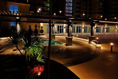 an empty courtyard at night with lights and plants at Boutique Studio- Riverine Diamond in Kuching