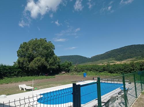 a swimming pool with a fence around it at Agroturismo Biltegi Etxea 
