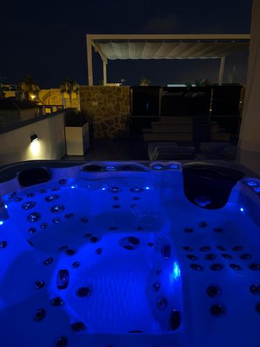 a jacuzzi tub with blue lights in the dark at PMT22 - Luxury villa with private heated pool and jacuzzi in Torrevieja