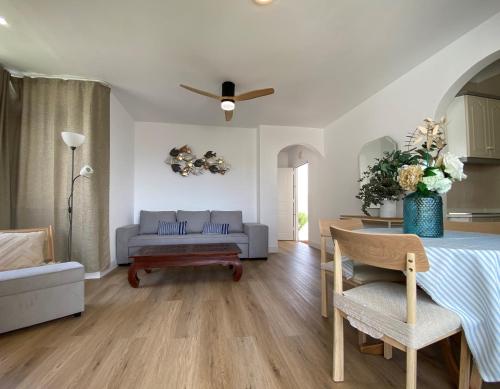 a living room with a table and a couch at Apartamento PLAYA LAS VENTANICAS in Mojácar