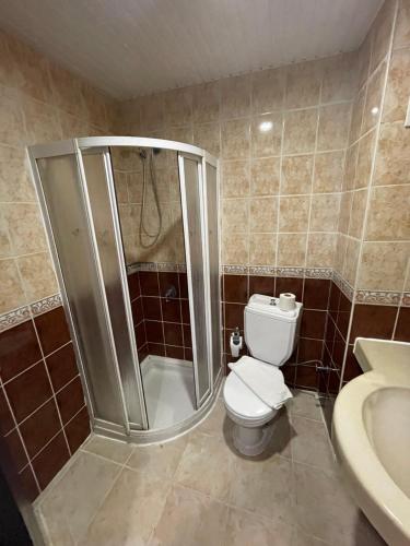 a bathroom with a shower and a toilet and a sink at CASTLE PARK HOTEL in Beldibi