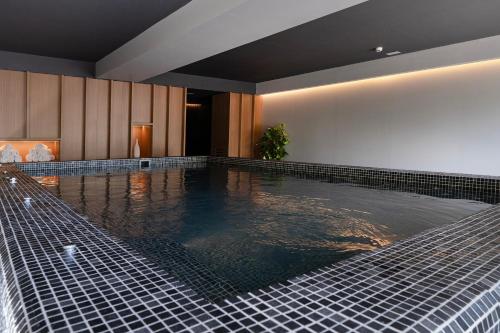 a large swimming pool in a hotel room with a pool at Bordoy Cosmopolitan in Playa de Palma