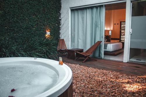 a bath tub in a room with a bedroom at Serena Buzios in Búzios