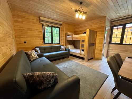 a living room with a couch and a bunk bed at Paye Suite in Uzungöl