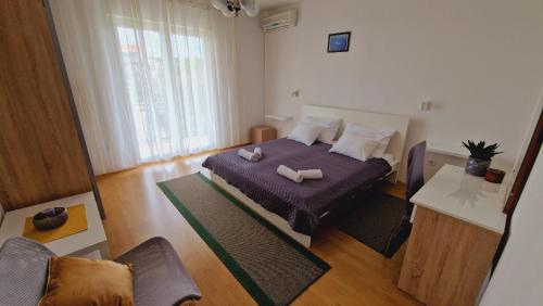 a bedroom with a bed with two pillows on it at Apartment Marica in Brodarica