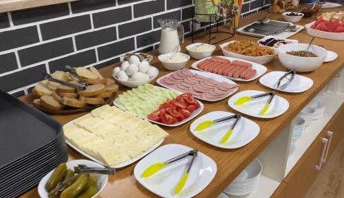 a table topped with plates of food on a counter at Hotel VS in Kobuleti