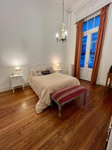 a bedroom with a bed and a large window at Refugio Francés en Buenos Aires in Buenos Aires