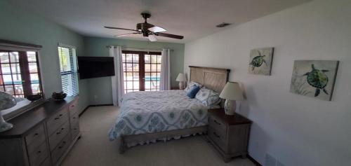 a bedroom with a bed and a ceiling fan at Getaway Canal in Palm Coast