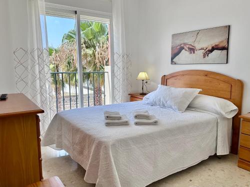 1 dormitorio con 1 cama con 2 toallas en Apartamento Playa Calahonda El Farillo con terraza, en Calahonda