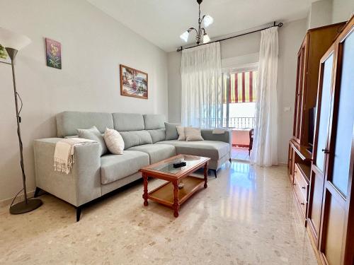 a living room with a couch and a table at Apartamento Playa Calahonda El Farillo con terraza in Calahonda