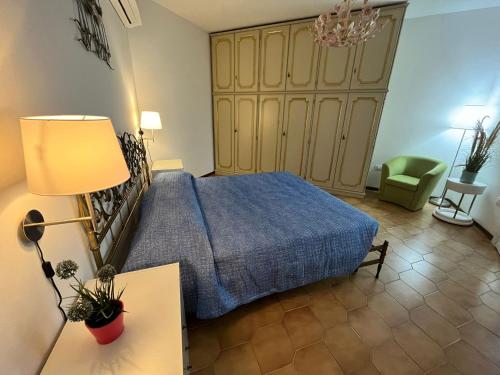 a bedroom with a bed and a table and a lamp at Finestra sul mare in Monfalcone