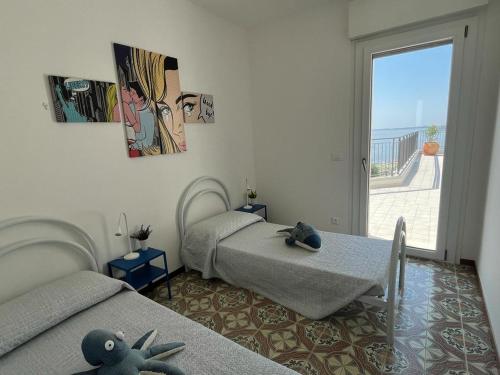 a bedroom with two beds with stuffed animals on them at Finestra sul mare in Monfalcone