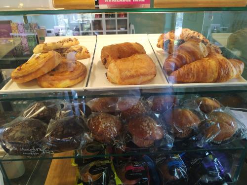 a display case with various pastries and pastries on trays at The Churchill Court in Woodstock