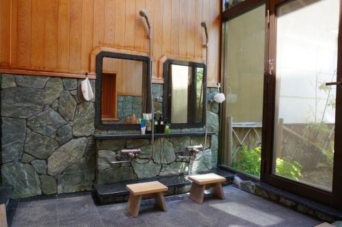 a bathroom with a sink and a mirror at Atelier Bee's Knees Bed & Breakfast in Ikuma