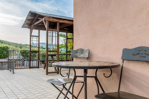 a table and two chairs sitting on a patio at Agriturismo Cantine Bevione - Rooms with air conditioning in Belvedere Langhe