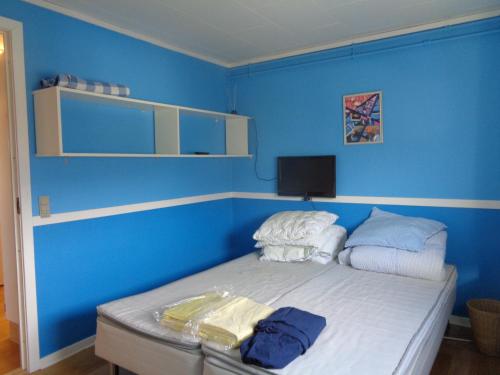 a blue room with a bed with blue walls at Sisimiut Bed & Breakfast in Sisimiut