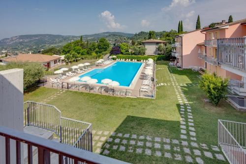 an external view of a villa with a swimming pool at Appartamenti San Carlo in Costermano