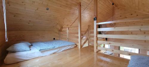 a room with a bed in a wooden cabin at Noclegi u Eli Zator Energylandia in Zator