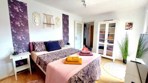 a bedroom with a bed with a pink blanket at Apartment Amarone, 4th floor, no elevator in Zagreb