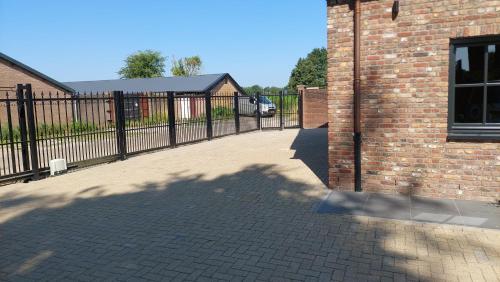 a wrought iron fence next to a brick building at B en B Stipdonk in Lierop