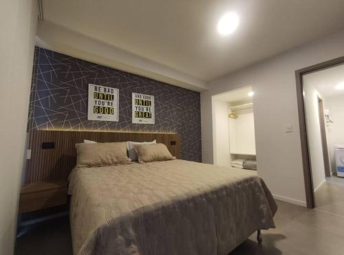 a bedroom with a large bed with a sign above it at Departamento en condominio de Equipetrol in Santa Cruz de la Sierra