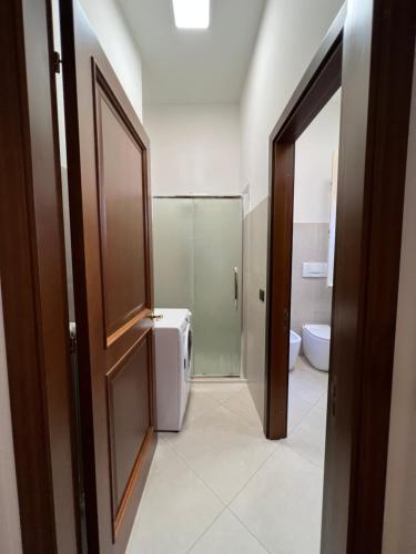 a bathroom with a refrigerator and a toilet in it at Appartamento del Duca in Senigallia