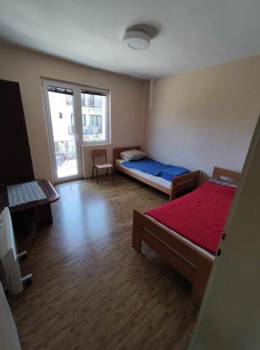 a large room with two beds and a window at Cozy Apartment Palazzo in Ohrid