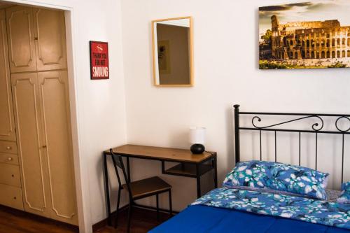a bedroom with a bed and a table and a desk at Praty Rooms in Rome