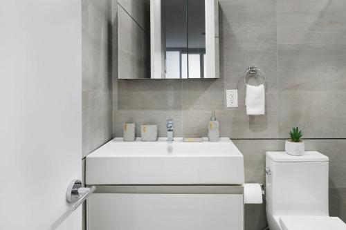 ein Badezimmer mit einem weißen Waschbecken und einem WC in der Unterkunft 78-3C Newly renovated 1BR WD Walk 2 Central Park in New York