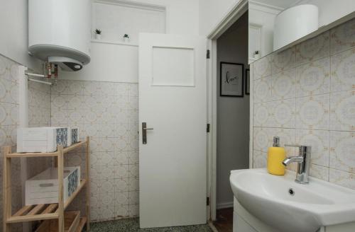 a bathroom with a sink and a white door at Lisbon - Low Cost - Airport - Subway in Lisbon