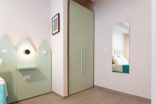 a glass door in a room with a bedroom at Oceano Rooms in Termoli