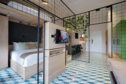 a bedroom with a bed and a tv on a wall at Comfy Loft in Santa Ana in Santa Pera