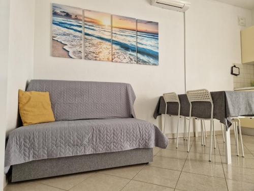 a living room with a couch and a table at Apartment Relax - 80 m from the beach in Sveti Filip i Jakov