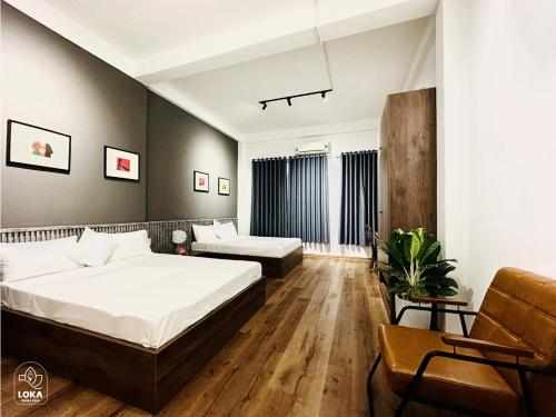 a bedroom with a bed and a couch at Loka Home & Yoga in Da Nang