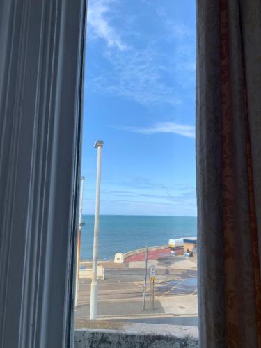 a view of the ocean from a window at Jini Hotel in Blackpool