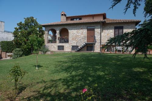 a large stone house with a large yard at Dolce Alba in Montecastrilli