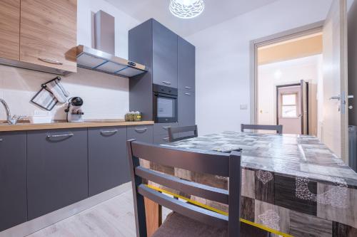 a kitchen with a large wooden table in a room at Damilhouse 1 in Messina