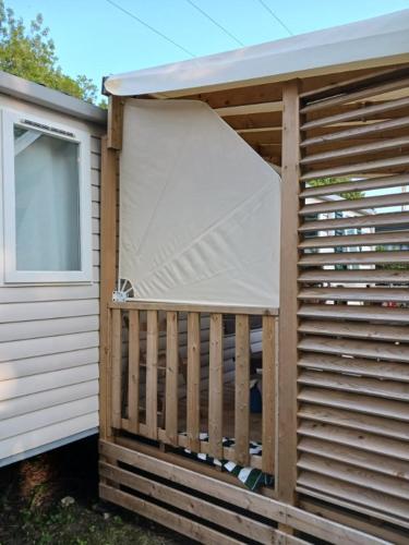 a building with a cover on the side of it at Mobilhome 6 pers avec Clim in Saint-Georges-de-Didonne