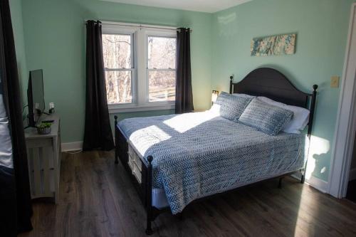 a bedroom with a bed and a window at Hidden Gem Secluded Home Steps from Bike Path in Schenectady