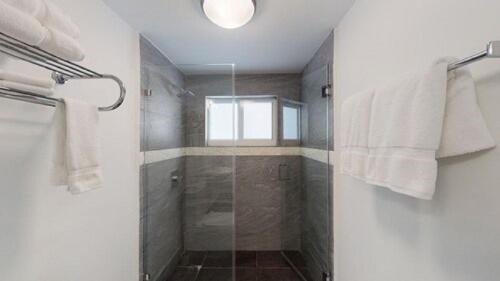 a bathroom with a shower with a glass door at Park Royal Miami Beach in Miami Beach