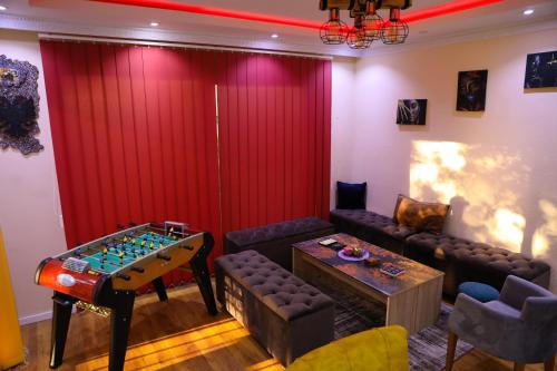 a living room with a table and agamuitous at City Park Hostel in Pristina
