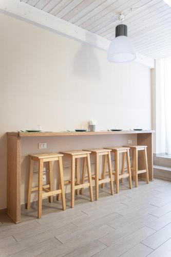 a kitchen with a table and some stools at Oceano Rooms in Termoli