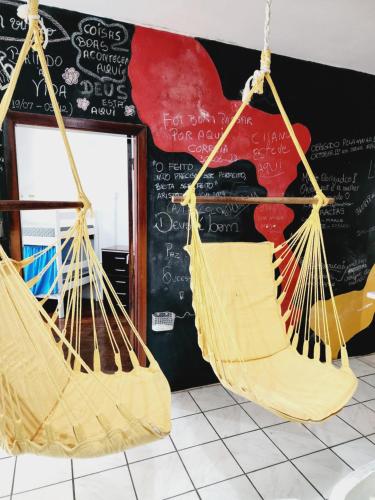 two hammocks hanging in front of a blackboard at Hostel Lumaria 1 in Blumenau