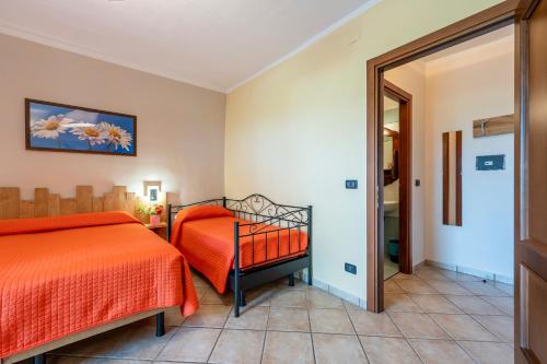 a bedroom with two beds and a mirror at Agriturismo Cantine Bevione - Rooms with air conditioning in Belvedere Langhe