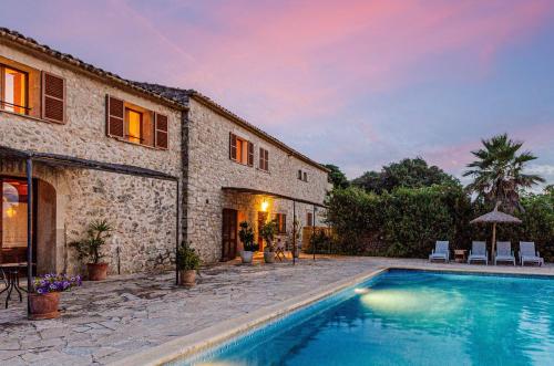 a house with a swimming pool next to a building at Finca es Rafal, Agroturisme in Montuiri