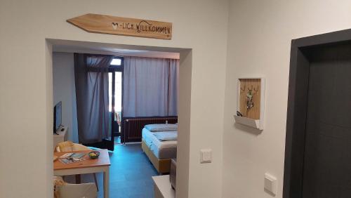 a hotel room with a bed and a table at Markus Apartment in Strobl