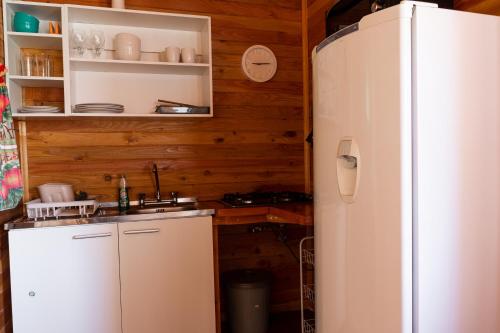 a kitchen with a refrigerator and a sink at Cabañas Mirador Lago Ranco in Lago Ranco
